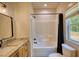 Bathroom showcasing a bathtub-shower combo with tiled walls and a modern sink vanity at 60 Browning Shoals Rd, Social Circle, GA 30025