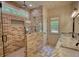 Beautiful bathroom with brick shower, double sinks, and natural light at 60 Browning Shoals Rd, Social Circle, GA 30025
