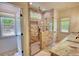 Modern bathroom boasts brick shower with glass door and double vanity sinks at 60 Browning Shoals Rd, Social Circle, GA 30025