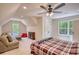 This bedroom features windows, carpet, seating area, ceiling fan, and a storage closet at 60 Browning Shoals Rd, Social Circle, GA 30025