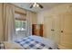 Bedroom features neutral walls, a ceiling fan, and a window with natural light at 60 Browning Shoals Rd, Social Circle, GA 30025