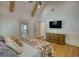 Spacious bedroom boasts beamed ceilings, hardwood floors, and a comfortable sitting area at 60 Browning Shoals Rd, Social Circle, GA 30025
