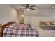 The primary bedroom with a ceiling fan, carpet, and a view into the bathroom and storage at 60 Browning Shoals Rd, Social Circle, GA 30025