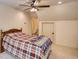 Bedroom features neutral walls, carpet, and a ceiling fan with access to the ensuite bathroom at 60 Browning Shoals Rd, Social Circle, GA 30025