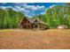 Exterior of home with front porch, beautiful landscaping, and spacious front yard at 60 Browning Shoals Rd, Social Circle, GA 30025