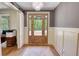 Stunning foyer with hardwood floors, a decorative chandelier, and a stylish front door with glass inserts at 60 Browning Shoals Rd, Social Circle, GA 30025