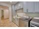 Well-equipped laundry room featuring modern appliances and ample cabinet storage at 60 Browning Shoals Rd, Social Circle, GA 30025