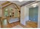 Spacious living room featuring vaulted ceilings, exposed wood beams, and sliding barn door to office space at 60 Browning Shoals Rd, Social Circle, GA 30025