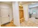 Mud room with brick floor, wood coat rack and storage with access to the laundry room at 60 Browning Shoals Rd, Social Circle, GA 30025