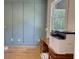 A home office shows a wood desk, light green walls, and a light colored hard wood floor at 60 Browning Shoals Rd, Social Circle, GA 30025