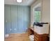 A home office shows a wood desk, light green walls, and a light colored hard wood floor at 60 Browning Shoals Rd, Social Circle, GA 30025