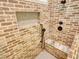 Luxury shower features a brick surround with a bench and rainfall shower head at 60 Browning Shoals Rd, Social Circle, GA 30025