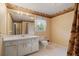Bathroom showcasing a large mirror, vanity with a sink, and toilet at 723 Monticello Se Way, Marietta, GA 30067