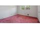 Empty bedroom featuring wall-to-wall carpeting, a window overlooking outdoors, and neutral-colored walls at 723 Monticello Se Way, Marietta, GA 30067