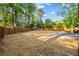 Extensive backyard space featuring a wooden fence, mature trees, and an outdoor seating area at 1554 Cardinal Rd, Jonesboro, GA 30238