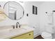 Stylish bathroom featuring a green vanity, round mirror, and sleek fixtures for a modern feel at 1554 Cardinal Rd, Jonesboro, GA 30238
