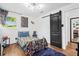 Fun bedroom with superhero-themed decor, wood floors, and a sliding barn door at 1554 Cardinal Rd, Jonesboro, GA 30238