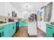 Modern kitchen featuring white cabinets, teal lower cabinets and stainless steel appliances at 1554 Cardinal Rd, Jonesboro, GA 30238