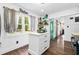 Well-lit modern kitchen featuring a white island and a teal accent door at 1554 Cardinal Rd, Jonesboro, GA 30238