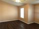 Bedroom with wood-look flooring, base trim, neutral walls and a single window at 1938 Dilcrest Dr, Duluth, GA 30096