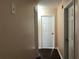 Hallway with wood-look floors, neutral walls and white doors leading to rooms at 1938 Dilcrest Dr, Duluth, GA 30096