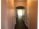 Hallway showcasing smooth walls and dark wood floors that lead to the main living areas at 1938 Dilcrest Dr, Duluth, GA 30096