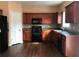 Well-equipped kitchen with black appliances, ample cabinet space, and wood-look flooring at 1938 Dilcrest Dr, Duluth, GA 30096