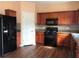 Well-equipped kitchen with black appliances, ample cabinet space, and wood-look flooring at 1938 Dilcrest Dr, Duluth, GA 30096