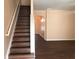 Stairwell has wood stairs, white trim, and is open to the entry and living space with wood-look floors at 1938 Dilcrest Dr, Duluth, GA 30096