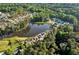 Aerial view of a residential community featuring a lake, tree lined streets, and green space at 2201 Old Dallas Sw Rd, Marietta, GA 30064