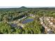Expansive aerial view of a neighborhood nestled around a peaceful pond, surrounded by lush green trees and nature at 2201 Old Dallas Sw Rd, Marietta, GA 30064
