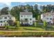 Charming backyard with a view of the serene lake from a multi-level deck, framed by lush greenery and a fence at 2201 Old Dallas Sw Rd, Marietta, GA 30064