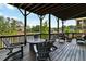 A covered deck with stylish outdoor seating and a fire pit overlooks a serene lake, perfect for relaxing and entertaining at 2201 Old Dallas Sw Rd, Marietta, GA 30064