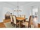 Dining room features hardwood floors, a modern chandelier, and seating for six at 2201 Old Dallas Sw Rd, Marietta, GA 30064