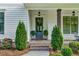 Cozy front porch with a blue door, lush greenery, and charming exterior details at 2201 Old Dallas Sw Rd, Marietta, GA 30064