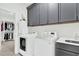 Laundry room features a front load washer and dryer, cabinets, and a sink at 2201 Old Dallas Sw Rd, Marietta, GA 30064