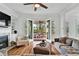 Bright living room featuring hardwood floors, fireplace, and French doors leading to an outdoor dining area at 2201 Old Dallas Sw Rd, Marietta, GA 30064