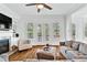Bright living room features hardwood floors, built-in shelving, and French doors leading to outdoor space at 2201 Old Dallas Sw Rd, Marietta, GA 30064