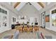 Bright lounge area featuring a long dining table, vaulted ceilings with wooden beams, and wood floors at 2201 Old Dallas Sw Rd, Marietta, GA 30064