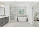 Bright bathroom featuring a soaking tub, walk-in shower, double vanity, and luxury finishes at 2201 Old Dallas Sw Rd, Marietta, GA 30064