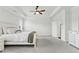 Bright main bedroom with a tray ceiling, a ceiling fan, and an open doorway at 2201 Old Dallas Sw Rd, Marietta, GA 30064