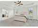 Spacious main bedroom with a tray ceiling, a ceiling fan, and a doorway into the main bathroom at 2201 Old Dallas Sw Rd, Marietta, GA 30064