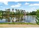 Picturesque view of a tranquil pond reflecting the blue sky and lush greenery, enhancing the property's natural beauty at 2201 Old Dallas Sw Rd, Marietta, GA 30064