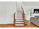 Bright staircase showcasing hardwood floors, white risers, and dark stained handrails at 2201 Old Dallas Sw Rd, Marietta, GA 30064