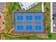 Overhead view of the fenced blue tennis courts with benches and manicured landscaping at 2201 Old Dallas Sw Rd, Marietta, GA 30064