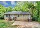Inviting single-story house with traditional architecture, set against a backdrop of lush greenery at 2952 Mcafee Rd, Decatur, GA 30032