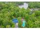 Aerial view of tennis courts and community pool surrounded by lush greenery at 3460 Wycherly Ne Ct, Brookhaven, GA 30319