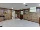 Finished basement featuring wood paneling, carpeted floors, and a Budweiser cooler on the floor at 3460 Wycherly Ne Ct, Brookhaven, GA 30319