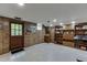 Spacious finished basement with wood paneled walls, neutral carpet and a door to the outside at 3460 Wycherly Ne Ct, Brookhaven, GA 30319