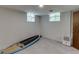 Unfinished basement with two windows, a gray floor, a white dehumidifier, and a surfboard at 3460 Wycherly Ne Ct, Brookhaven, GA 30319